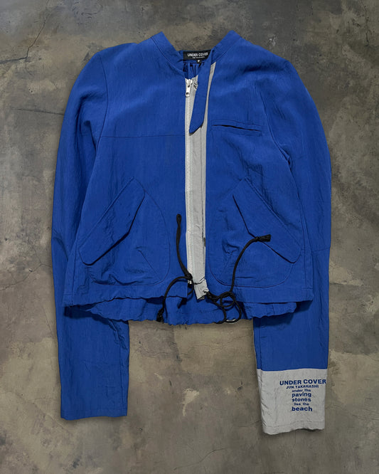 UNDERCOVER SS1995 "UNDER THE PAVING STONES LIES THE BEACH" WINDBREAKER