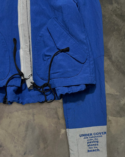 UNDERCOVER SS1995 "UNDER THE PAVING STONES LIES THE BEACH" WINDBREAKER